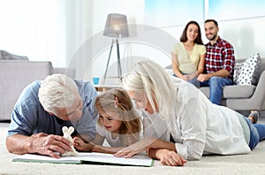 Mature couple spending time with their graddaughter at home. photo