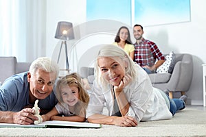 Mature couple spending time with their granddaughter at home. photo