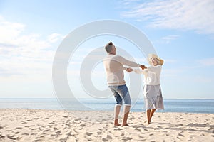 Mature couple spending time together on beach