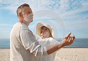 Mature couple spending time together on beach