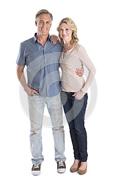 Mature Couple Standing With Hands In Pockets