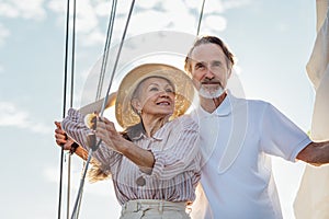 Mature couple standing on a yacht