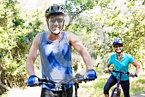 Mature couple with sunglasses riding bike