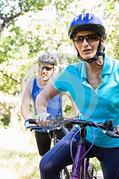 Mature couple with sunglasses riding bike