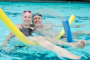 Mature couple swimming in pool