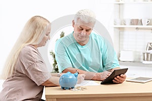 Mature couple thinking over pension payment