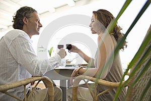 Mature Couple toasting and having lunch. photo