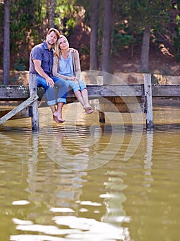 Mature couple, together and relax in lake, countryside and commitment with love in marriage. Happiness, smile and hug by