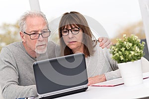 Mature couple using laptop