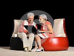 Mature couple using laptop