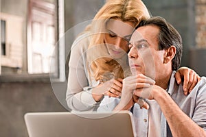 Mature couple using laptop together at home