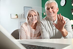 Mature couple using video chat on laptop