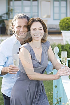 Mature couple on vinyard balcony.