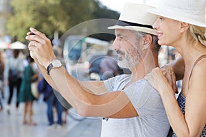 mature couple visiting old city street monument