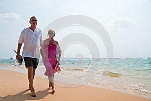 Mature couple walking on beach