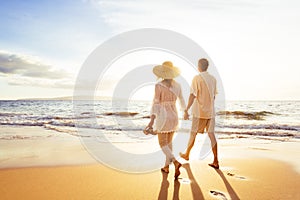 Mature Couple Walking on the Beach at Sunset