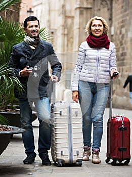 Mature couple walking with luggage