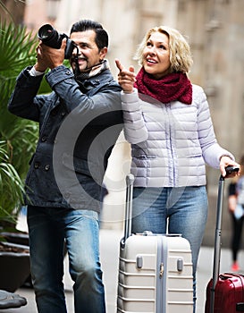 Mature couple walking with luggage