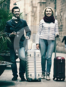Mature couple walking with luggage