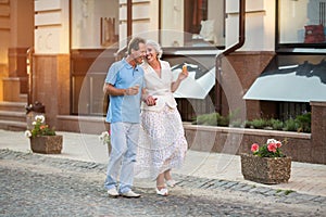 Mature couple walking and smiling.