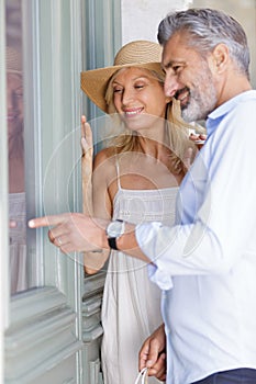 mature couple window shopping