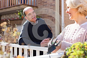 Mature cuople talking at balcon photo