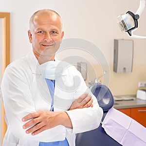 Mature dentist surgeon at office