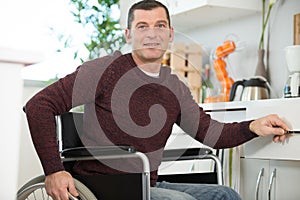 mature disabled man in kitchen