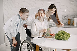 Mature disabled woman cutting vegetables in the kitchen