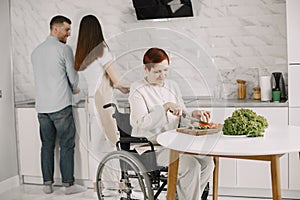 Mature disabled woman cutting vegetables in the kitchen