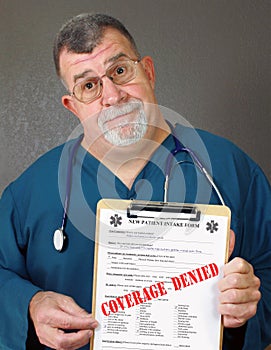 Mature Doctor Displays Coverage Denied
