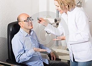 Mature doctor examinating eyesight