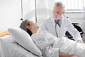 mature doctor examining african american women