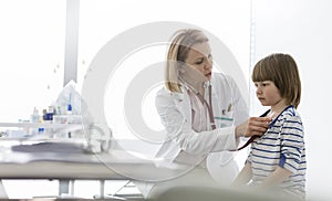 Mature doctor examining boy at hospital