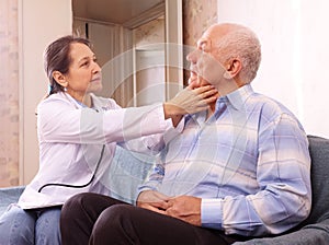 Mature doctor examining senior man