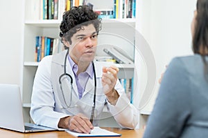 Mature doctor explaining problems to female patient