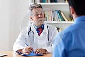 Mature doctor explaining therapy to patient