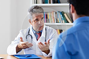 Mature doctor explaining treatment to patient