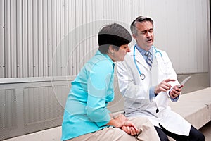 Mature doctor with female patient