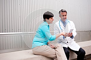 Mature doctor with female patient