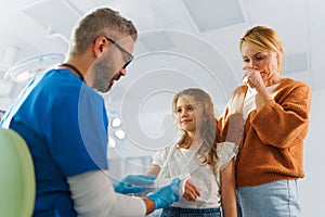 Mature doctor giving gypsum to little girl.