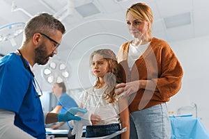 Mature doctor giving gypsum to little girl.