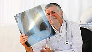 Mature doctor looking at a scan