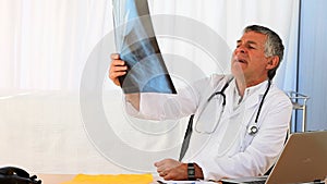 Mature doctor looking at a scan