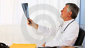 Mature doctor looking at a scan