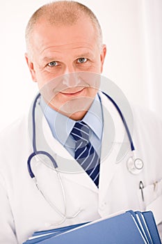 Mature doctor male portrait with folders photo