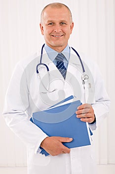 Mature doctor male portrait with folders photo