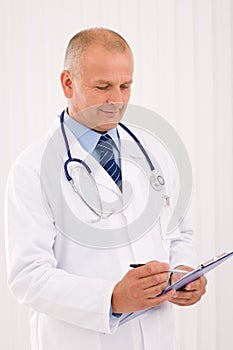 Mature doctor male portrait write document
