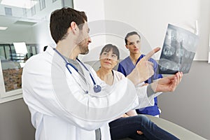 Mature doctor in office looking at xray results photo