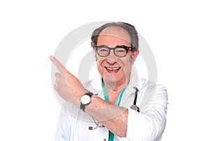 Mature doctor pointing upwards and away